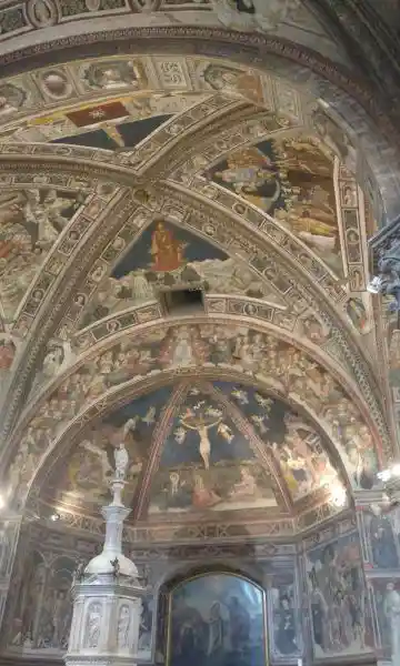 Light at the center of a cross on the ceiling of Siena Cathedral